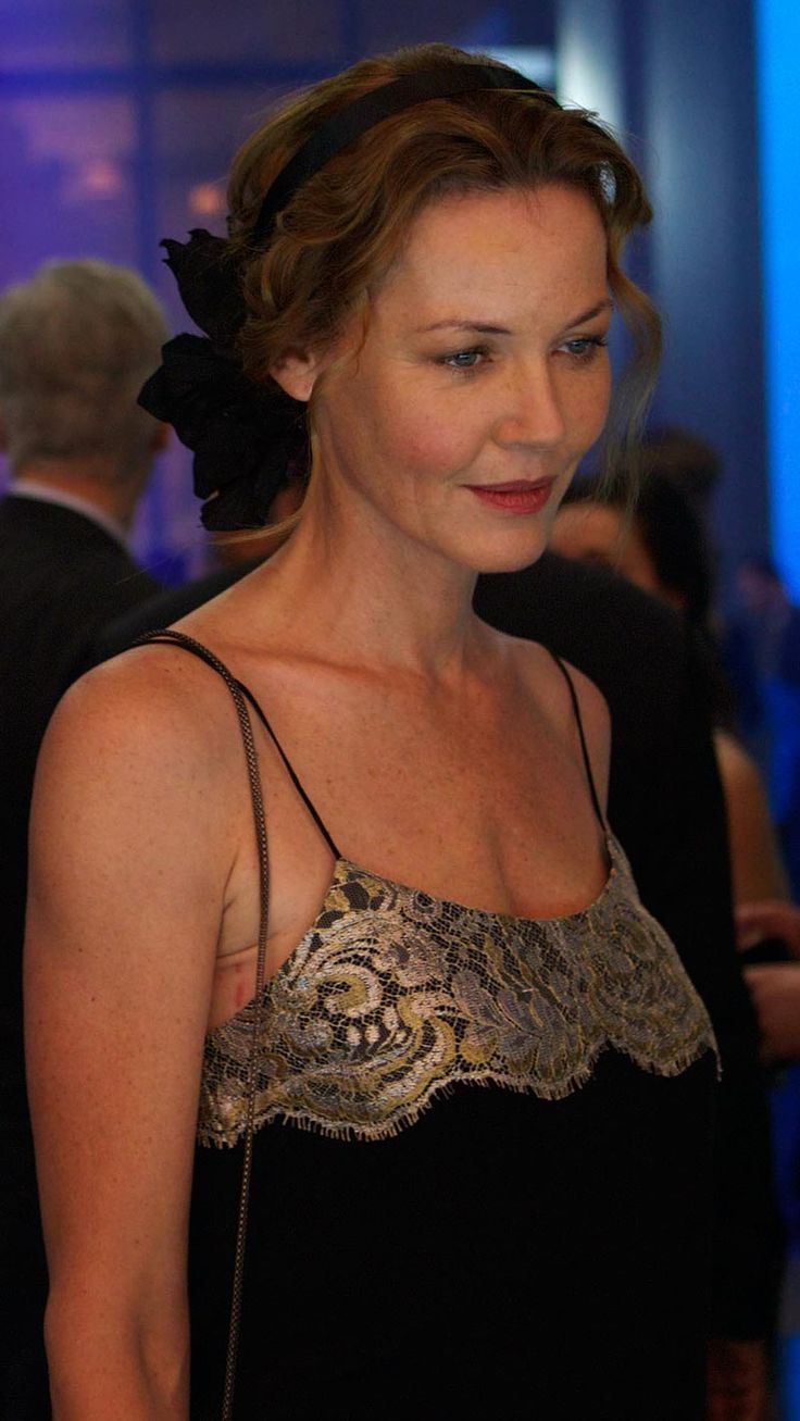 a woman in a black dress with a flower in her hair