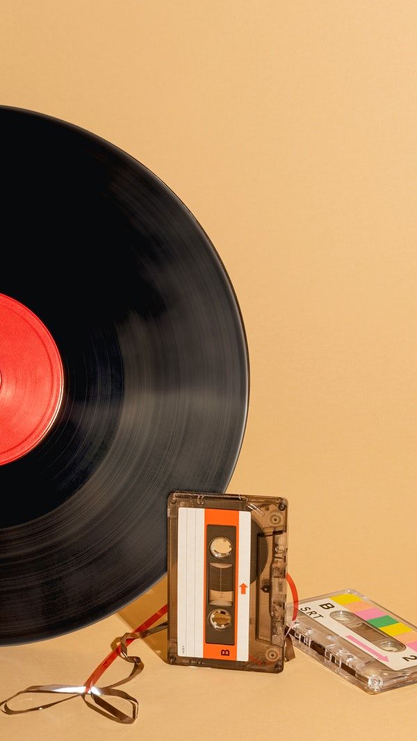 an old fashioned record player and tape recorder on a table with a red disc in the middle