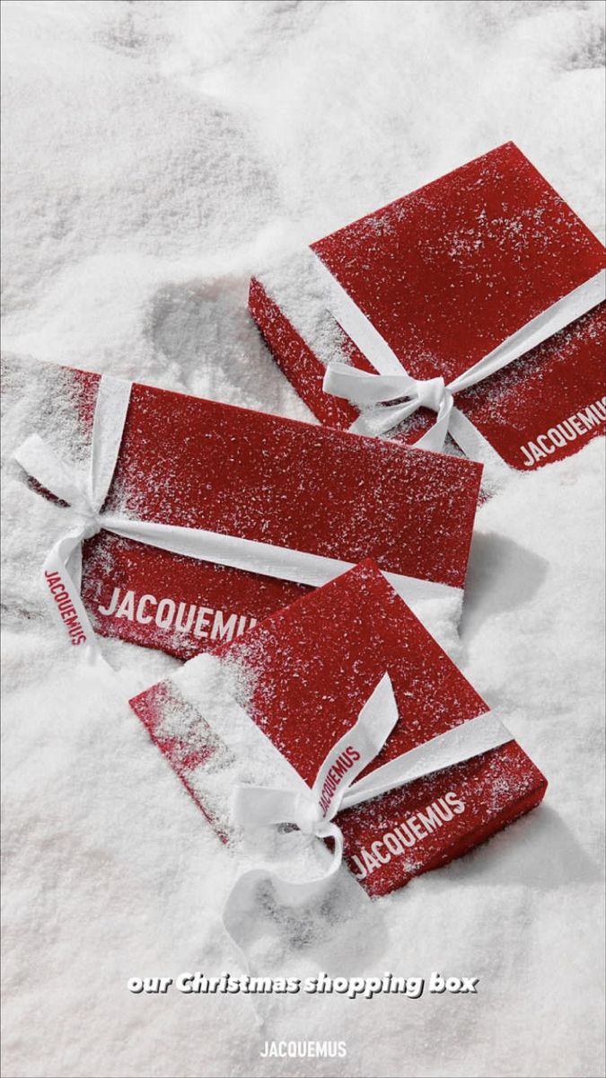 three red tags with white ribbon tied around them in the snow that says jacquemin