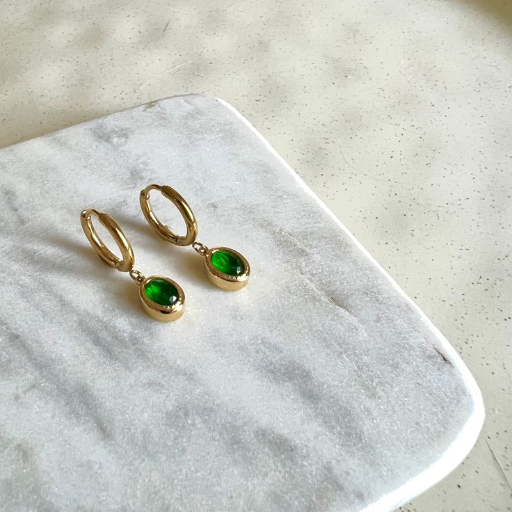 Dainty Created Emerald Gemstone Dangle Hoop Earrings Titanium 18K Gold Filled Earrings Hypoallergenic. Delicate and simple, fitting everyday wear. Stone Height: 8 mm  Stone Width: 3.5 mm Hoop inner diameter: 11 mm PRODUCT DETAIL ✧ Sold as pairs ✧ ✧ Titanium base with 18K Gold fill ✧ ✧ Nickel free Hypoallergenic and Waterproof✧ ✧ Handcrafted by our in-house jeweller✧ ✧ All packages shipped from Toronto ✧ ✧ Gift-ready packages with each order ✧ Hey! Before placing your order, why not check out oth Green Small Hoop Earrings Tarnish Resistant, Small Hoop Green Earrings Tarnish Resistant, Green Minimalist Small Hoop Huggie Earrings, Small Hoop Green Tarnish-resistant Earrings, Green Tarnish Resistant Small Hoop Earrings, Elegant Everyday Hoop Earrings With May Birthstone, Minimalist May Birthstone Earrings, Minimalist Green Hoop Huggie Earrings, Green Minimalist Huggie Hoop Earrings