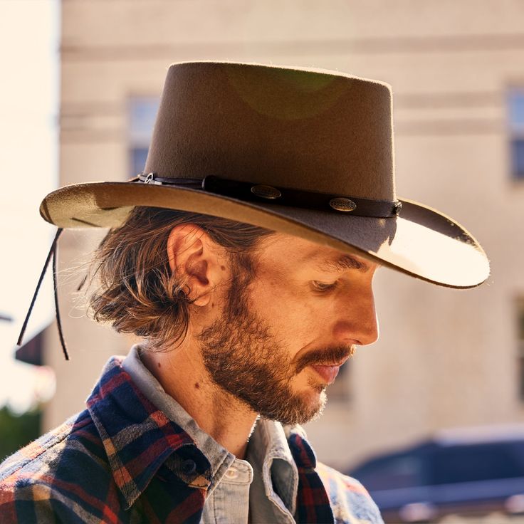 This western-inspired fashion hat brings a welcome pop of Cowboy Core to any look. Its bold silhouette features a statement-making 3 1/2" telescope crown, 3 1/2” downturn brim and leather hat band with silver-tone conchos. Handmade in the U.S.A. with a firm finish from high-quality wool felt, it’s finished with a faux leather sweatband and satin liner for a comfortable, all-day fit. 3 1/2" Telescope Crown 3 1/2" Downturn Brim Leather Hat Band With Silver-Tone Conchos Faux Leather Sweatband Satin Cut Tees, Straw Cowboy Hat, Denim Boots, Outdoor Men, Leather Hats, Western Hats, Mini Shirt Dress, Western Shirts, Tee Dress