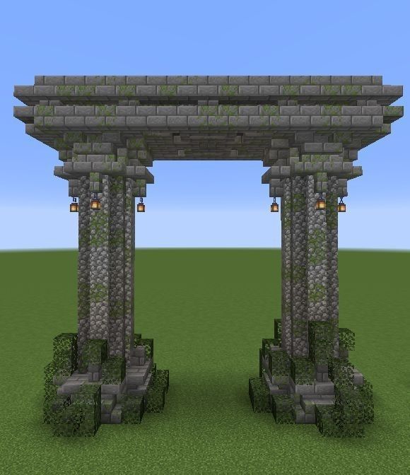 two stone pillars in the middle of a field