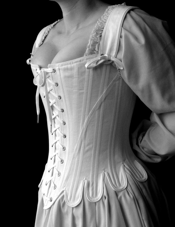 This 18th century corset is rigidly boned with closely spaced 1/4" steel bones and is cut to enhance and lift the bust, and shape the waist. The additional lacing up the center front allows for increased adjustment. The waist tabs, cut in one with the corset, curve and smooth over the hips. The over the shoulder straps adjust with a front tie and are basted in at the back. The straps are easily removable. Strapless stays are one of the signature looks of this period.  Add a pocket stomacher! https://www.etsy.com/listing/1552668927/add-a-pocket Features include: Ø Side seam alteration point for an adjustable fit  Ø Center front and back lacing Ø  Shoulder straps adjust with a front lacing and are removable Available in size small-2XL or custom sized to your measurements (custom measurements 18th Century Stays, Style Corset, 18th Century Clothing, Century Dress, Lady Mary, 18th Century Fashion, White Corset, Century Clothing, Period Costumes