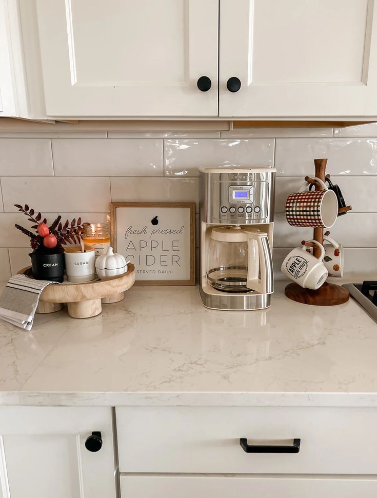 a kitchen counter with coffee maker and other items on it