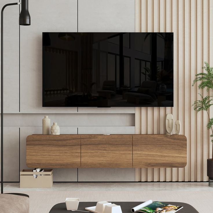 a flat screen tv mounted to the side of a wooden entertainment center in a living room