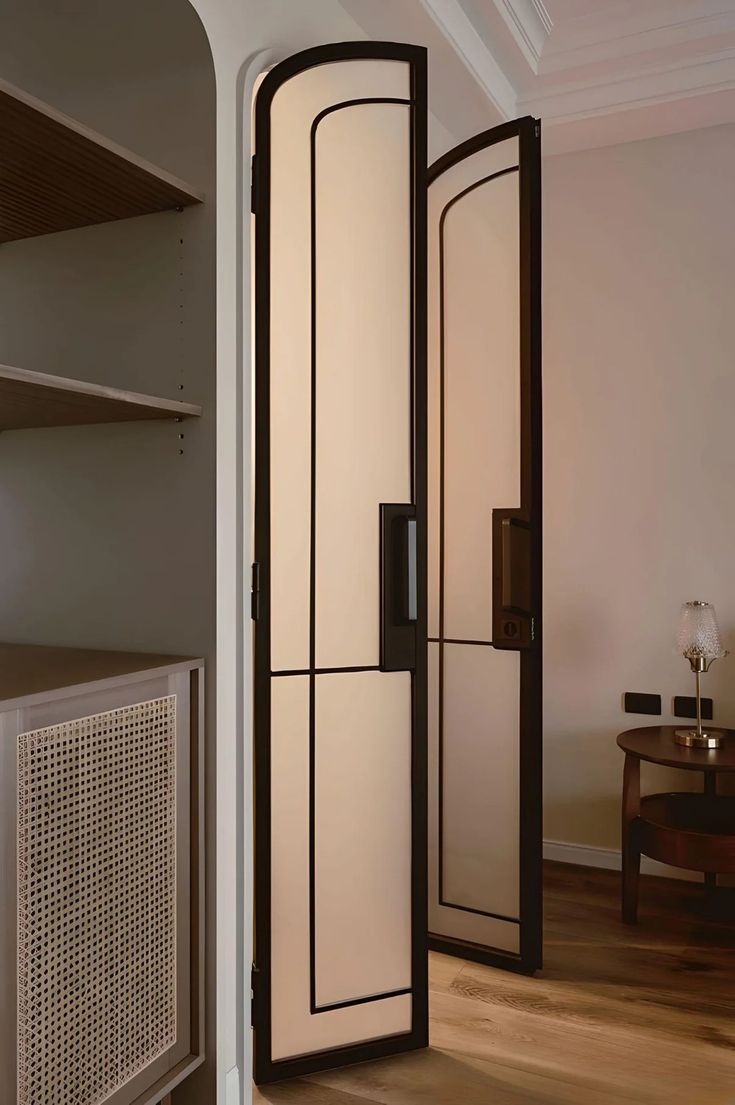 a room divider in the middle of a wooden floor with shelves on either side