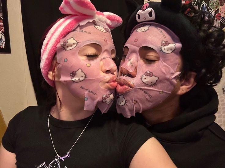 two people with pink masks on their faces