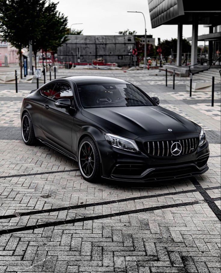 a black car parked in front of a building