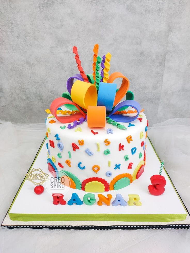 a birthday cake with colorful decorations on it