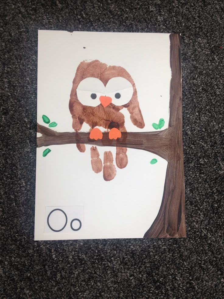 an owl is sitting on a tree branch