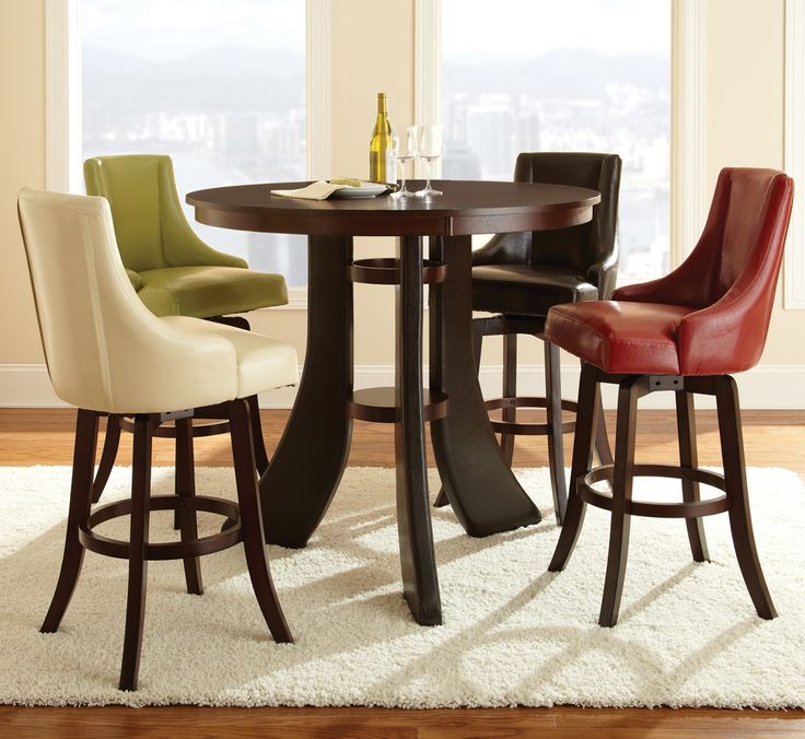 a dining room table with four chairs around it