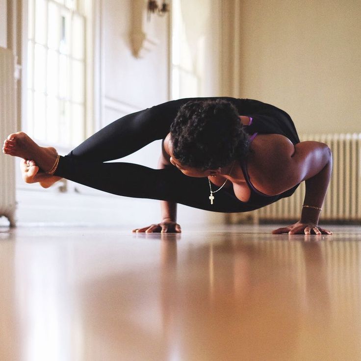 a woman is doing yoga on the floor