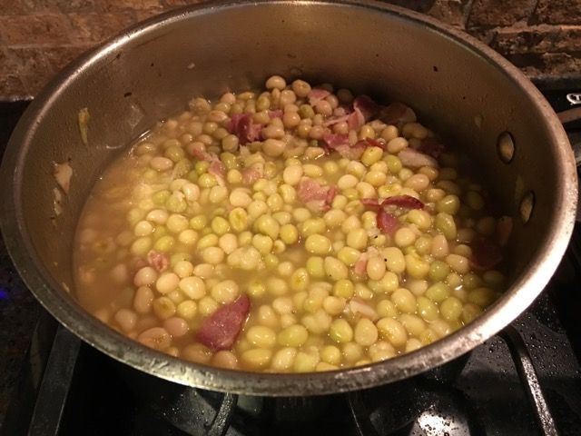 a pot filled with food sitting on top of a stove