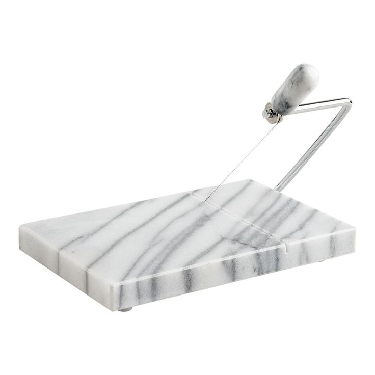 a white marble cutting board with a knife sticking out of it