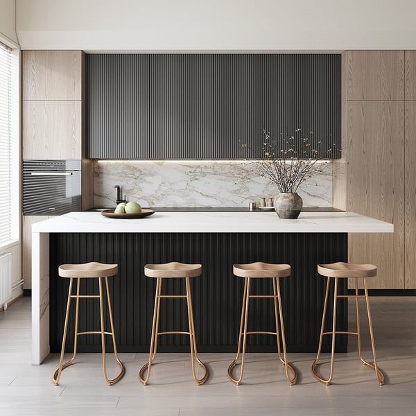 three stools sit in front of an island with marble countertops and black cabinets