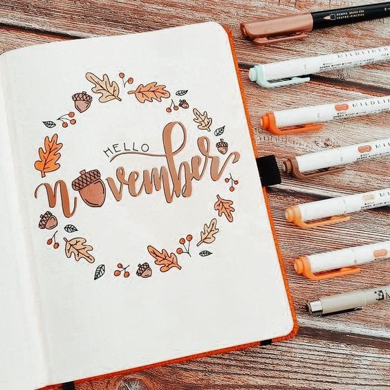 an open notebook with the words hello november written in cursive writing on it