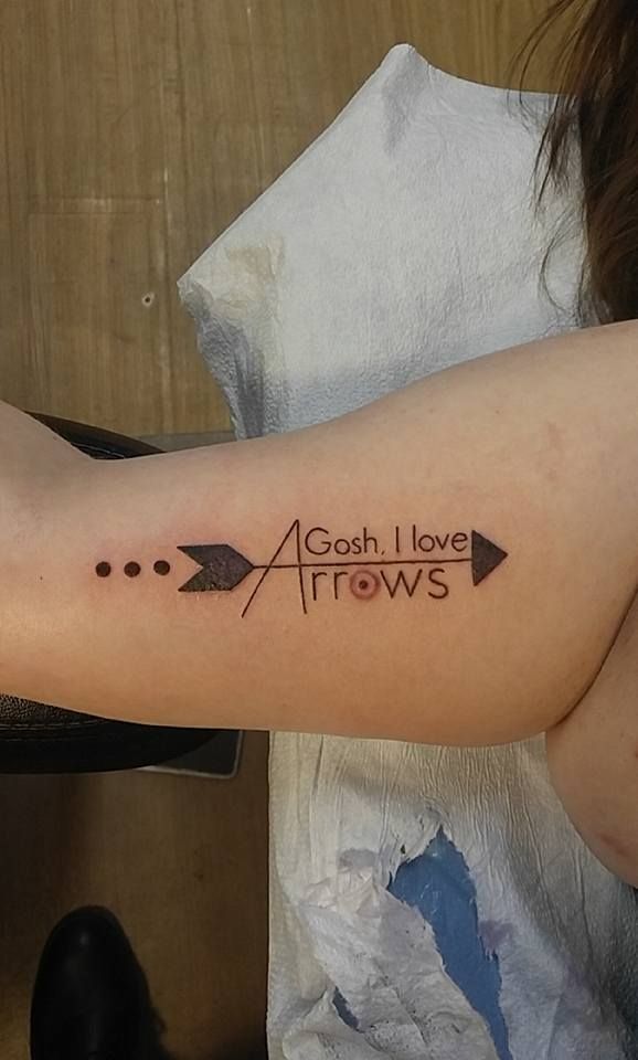 a woman's arm with an arrow tattoo that says aosh i love arrows