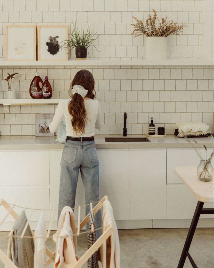 a woman standing in front of a kitchen counter