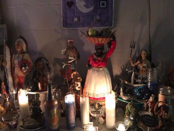 a table topped with lots of candles and figurines