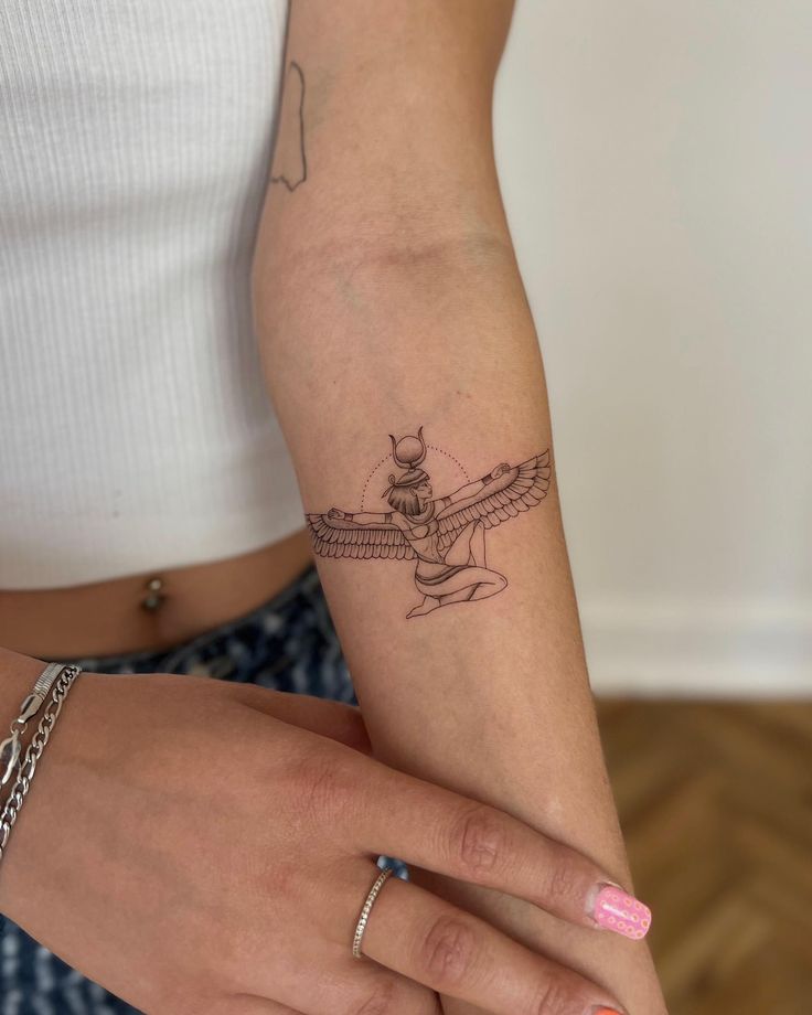 a woman's arm with a small tattoo on the left side of her arm