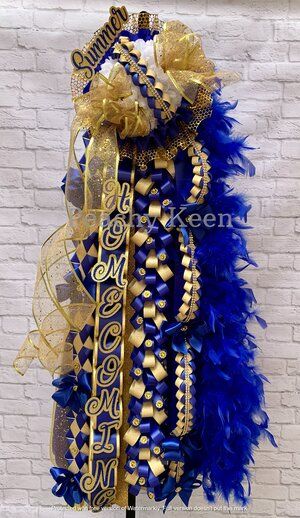 a blue and gold feathered wreath on a brick wall