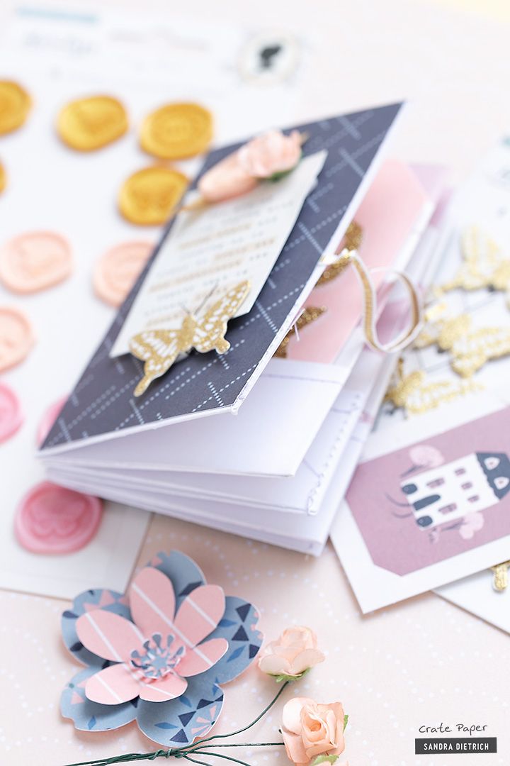 a close up of some cards with flowers and buttons on the top of one card