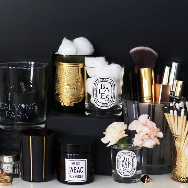 several different types of makeup brushes and containers