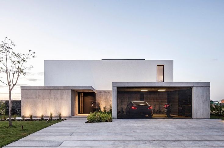 a car is parked in front of a modern house