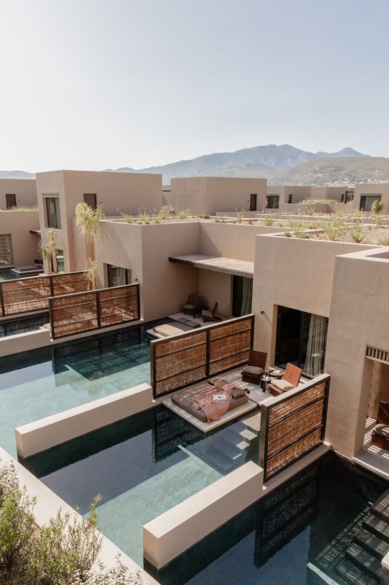 an outdoor swimming pool surrounded by lounge chairs