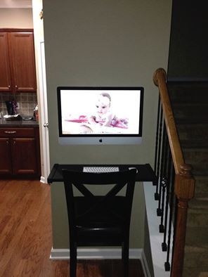 a flat screen tv mounted to the side of a wall next to a stair case