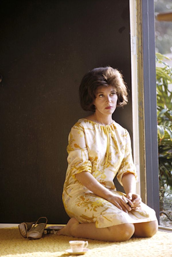 a woman sitting on the floor with her legs crossed