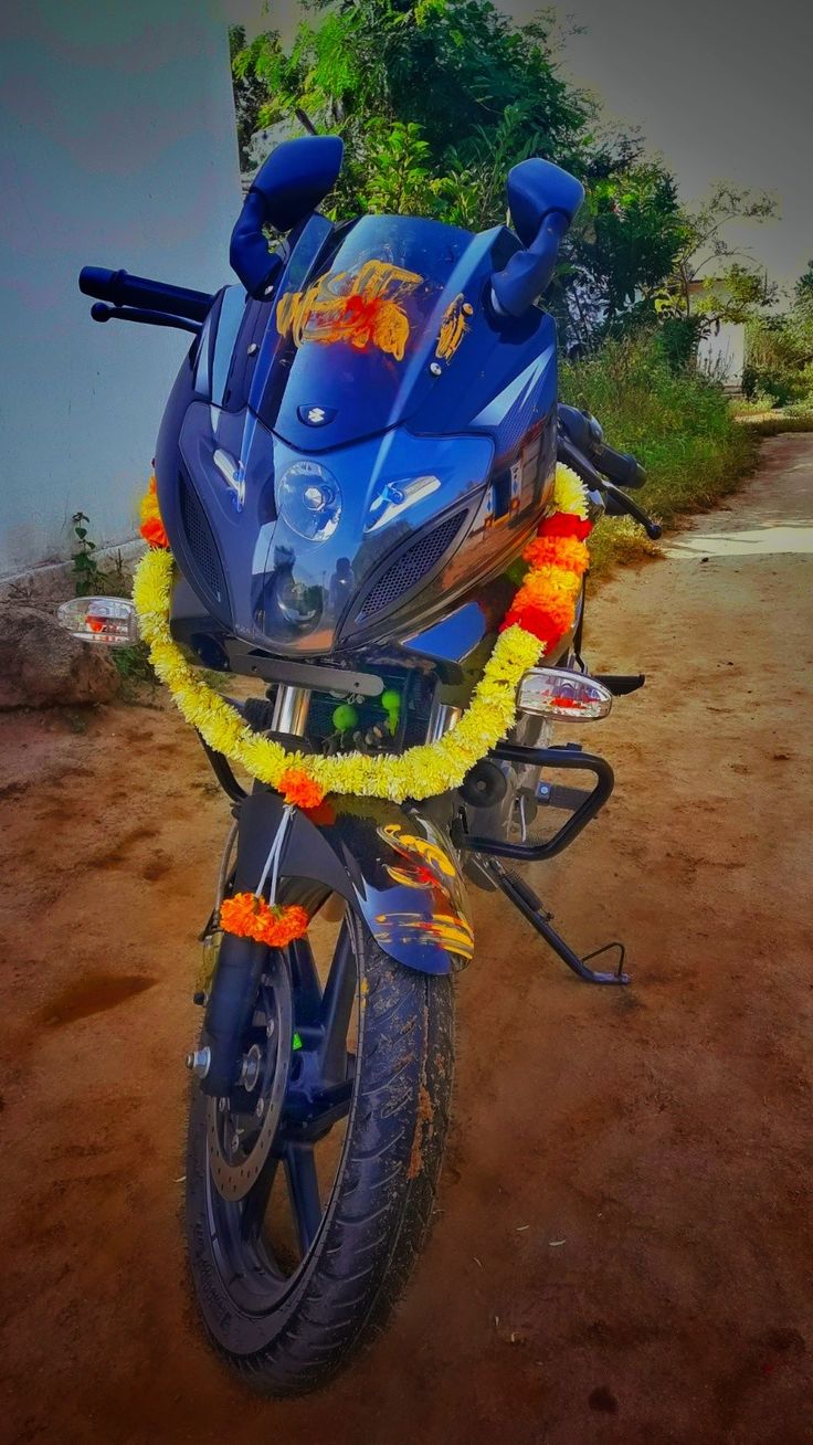 a blue motorcycle parked on top of a dirt road