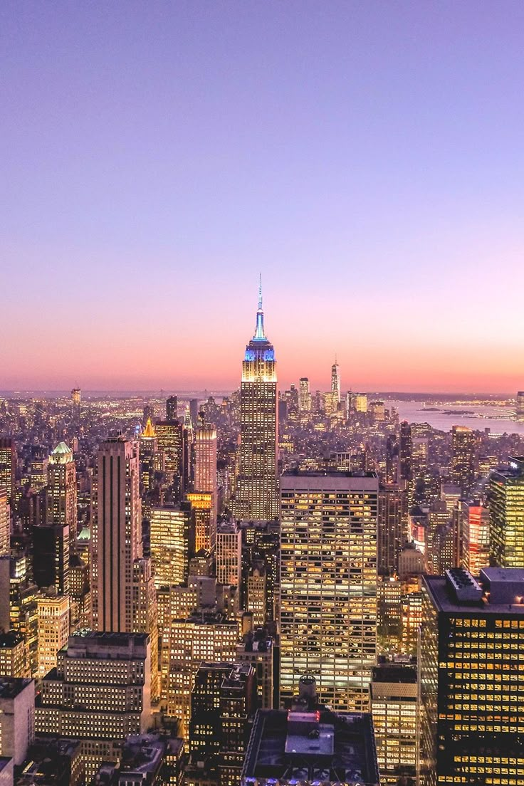 new york city skyline at sunset with the empire building in the foreground