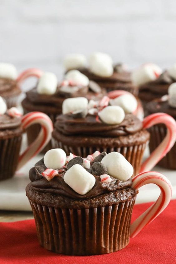 chocolate cupcakes decorated with candy canes and marshmallows