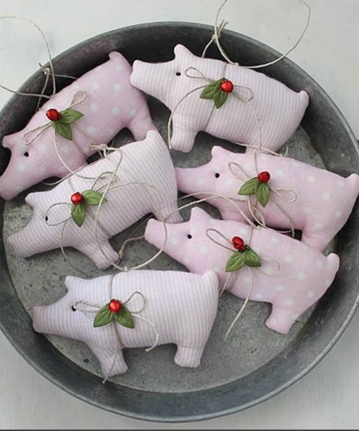 small pink pig ornaments in a bowl on a table