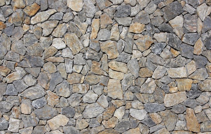 a stone wall that looks like it has been made out of various types of rocks