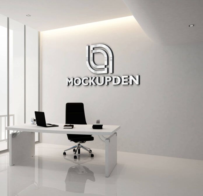 an office with a white desk and black chairs in front of the logo on the wall