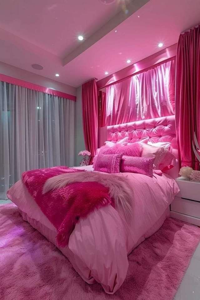 a bedroom with pink walls and carpeted flooring is decorated in shades of pink