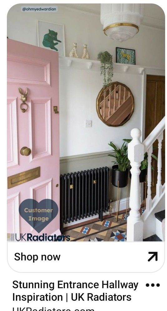 a pink door in front of a white wall and some pictures on the wall above it