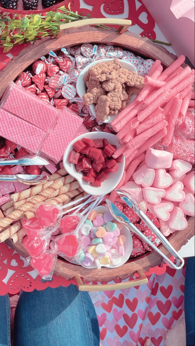 a wooden tray filled with lots of candy and candies