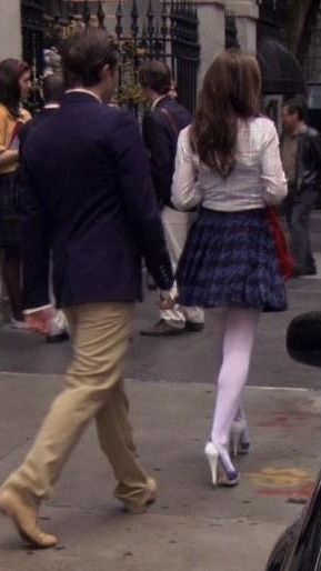 a man and woman walking down the street