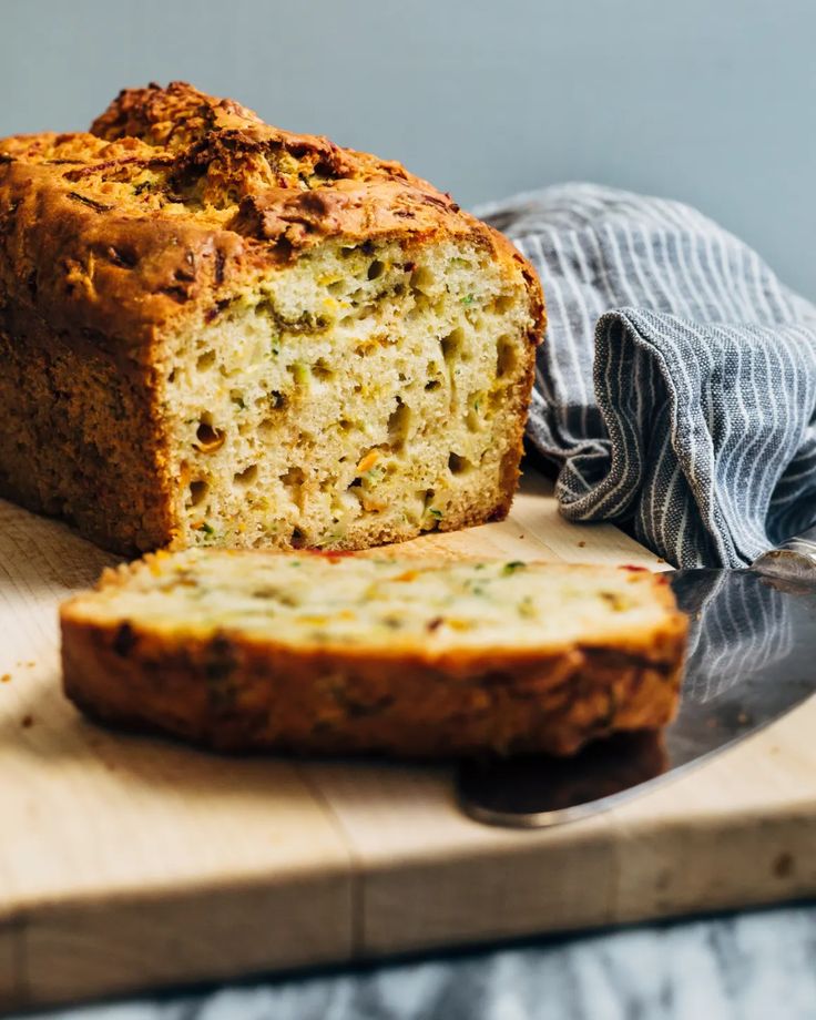 a loaf of zucchini bread sitting on top of a cutting board