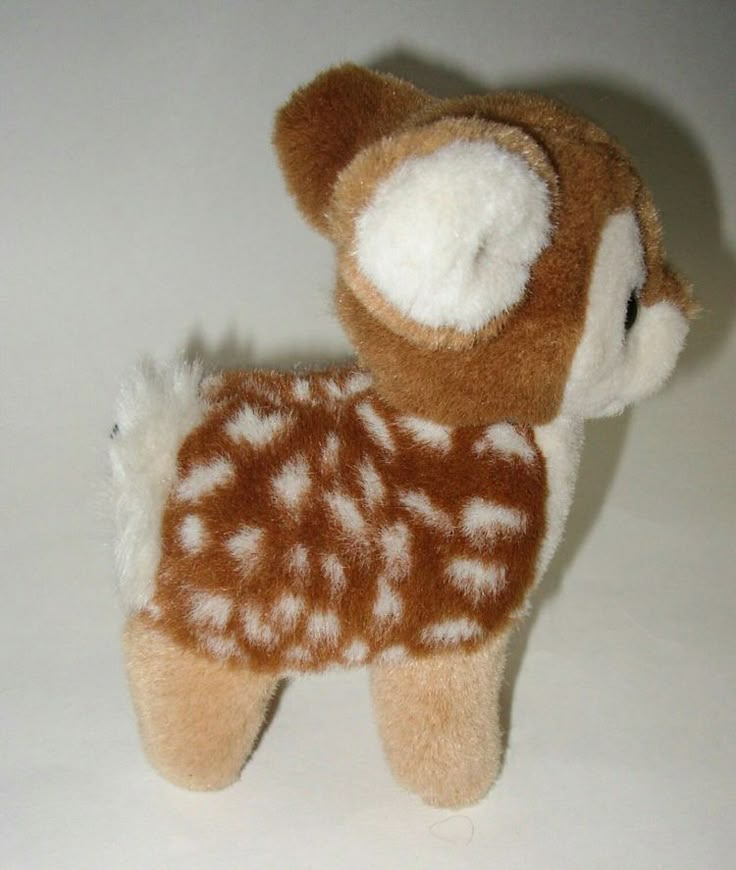 a brown and white stuffed animal with spots on it's body