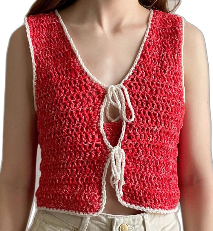 a woman wearing a red crochet top with white trimmings on her chest