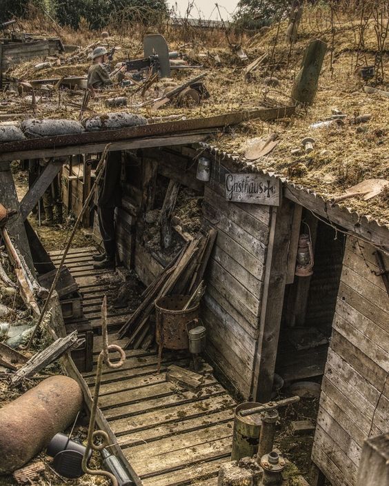 an old run down shack with lots of junk on the roof and stairs leading up to it