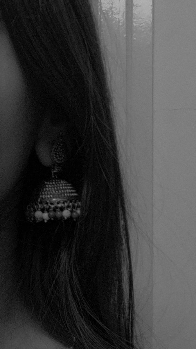 black and white photograph of woman wearing earrings