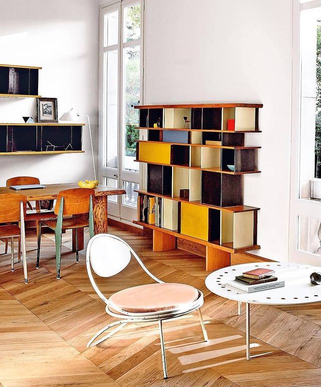 a living room filled with furniture and bookshelves