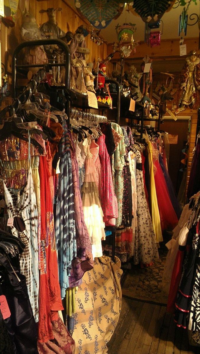 there are many dresses on display in the store, and one is hanging from the ceiling