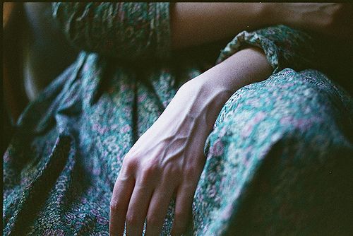 a woman's hand resting on the back of a couch