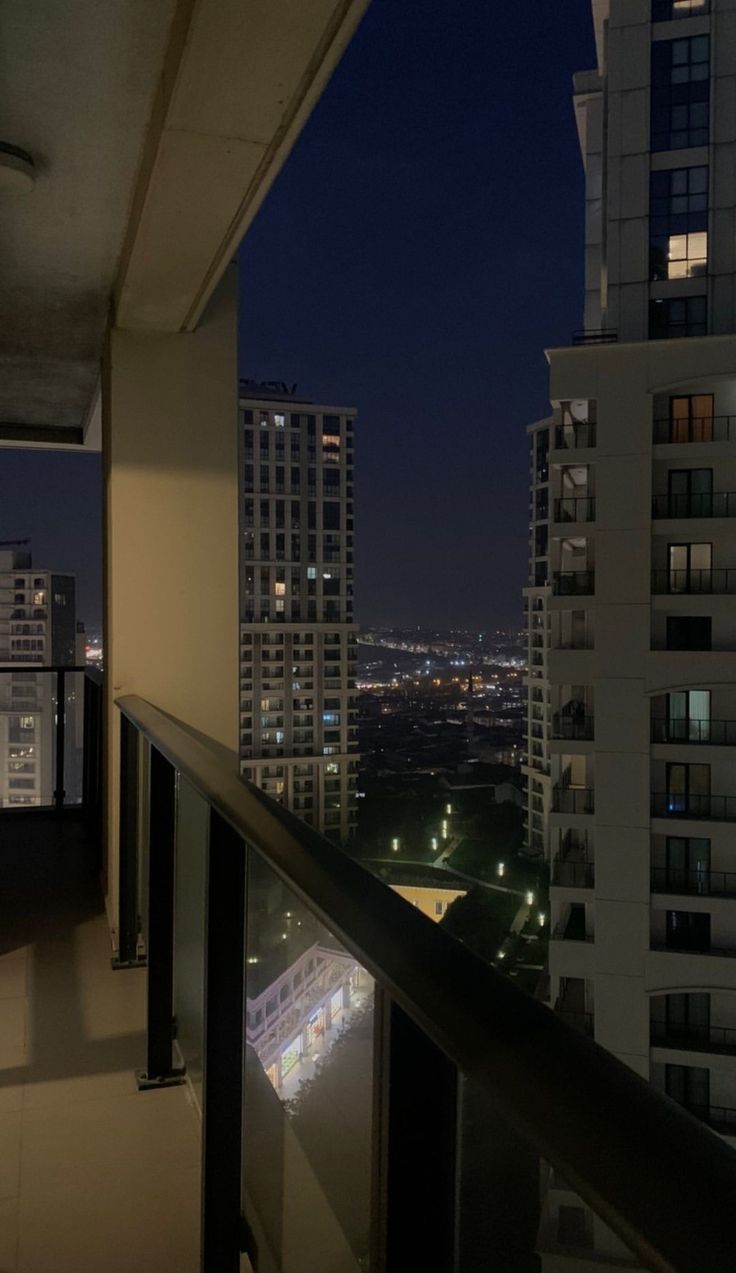 a balcony overlooking the city at night with no one on it or in the distance